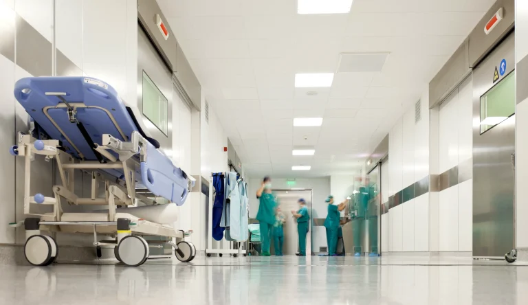 Hospital corridor with clinical staff and medical equipment