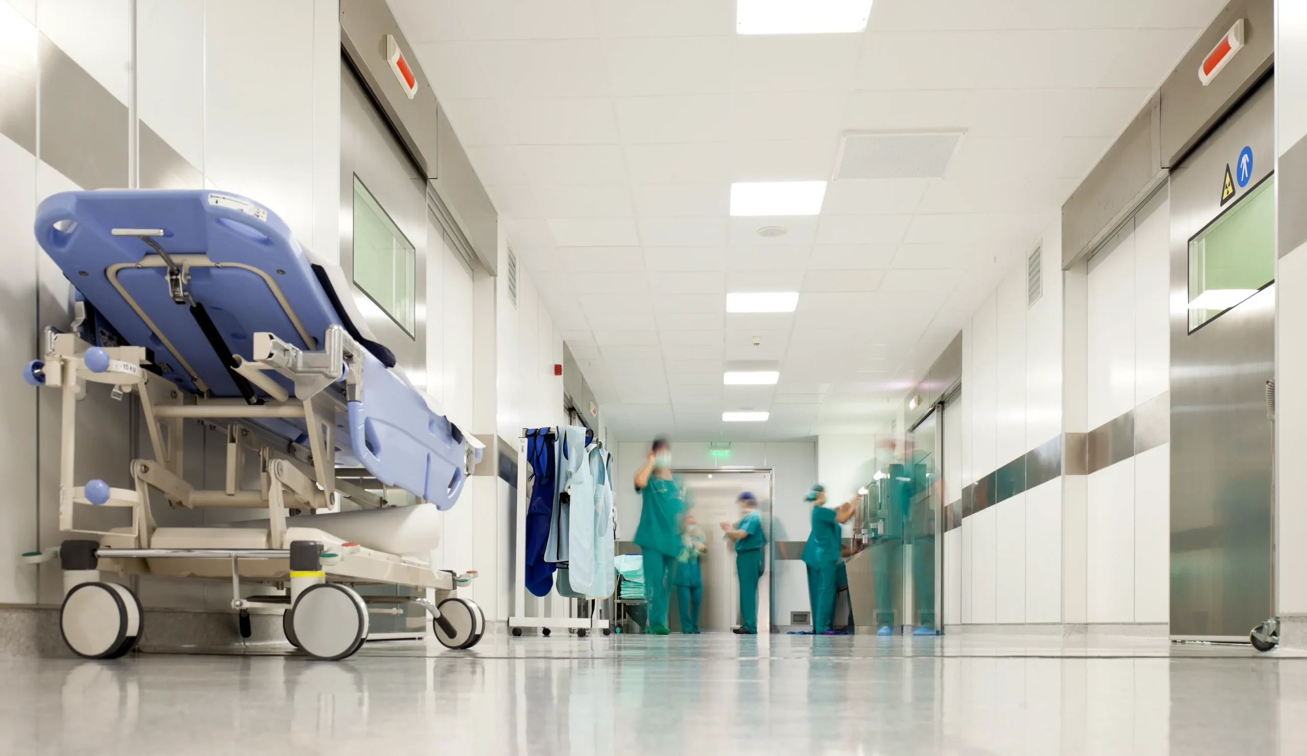 Hospital corridor with clinical staff and medical equipment