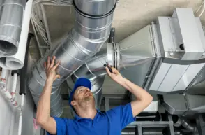 HVAC engineer inspecting ventilation ductwork during commissioning