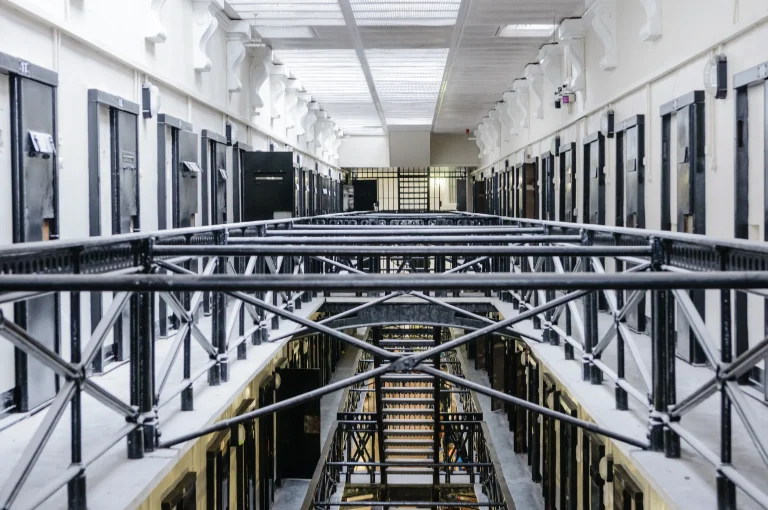 Secure prison interior with cell doors and service infrastructure