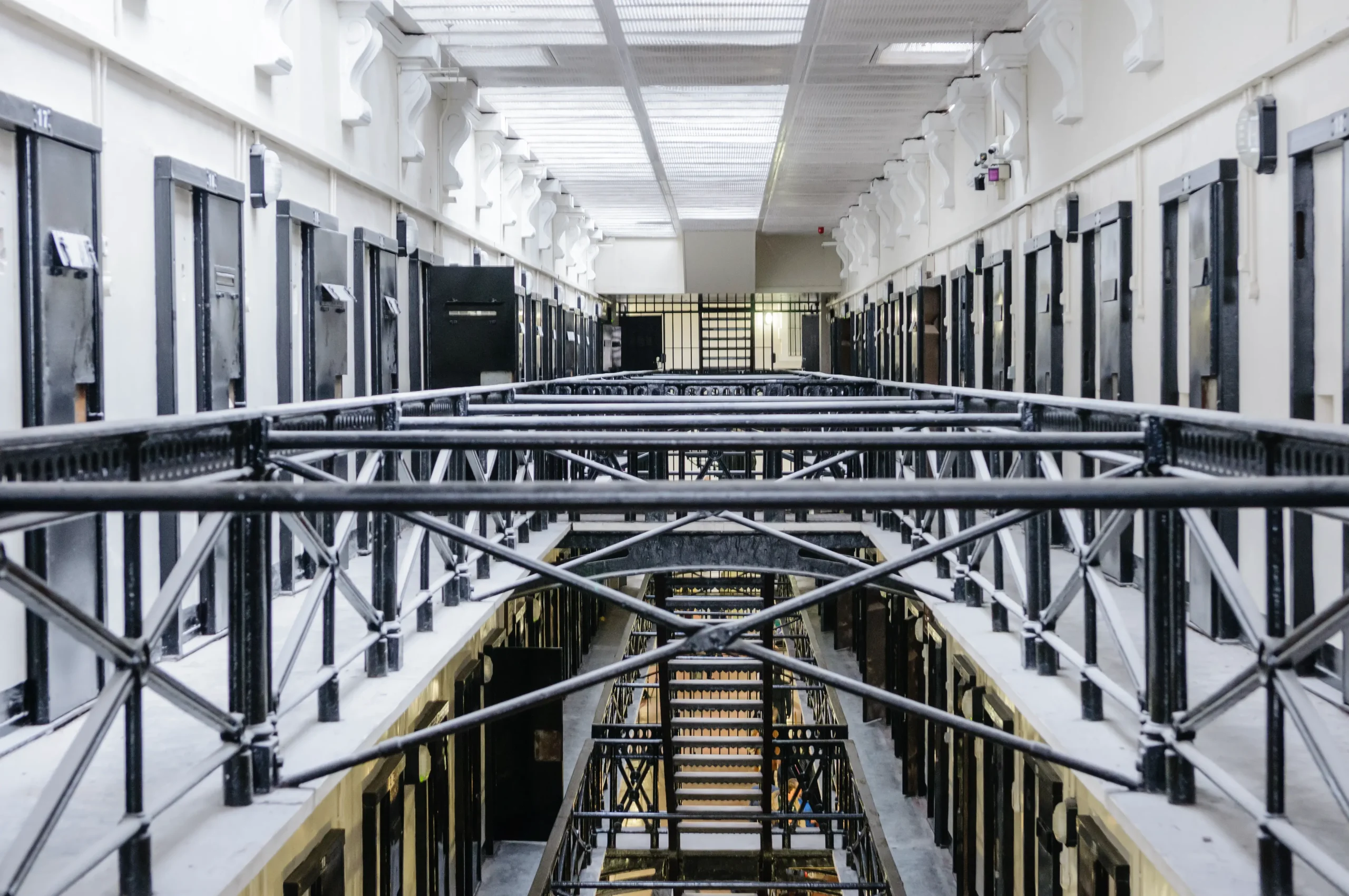 Secure prison interior with cell doors and service infrastructure