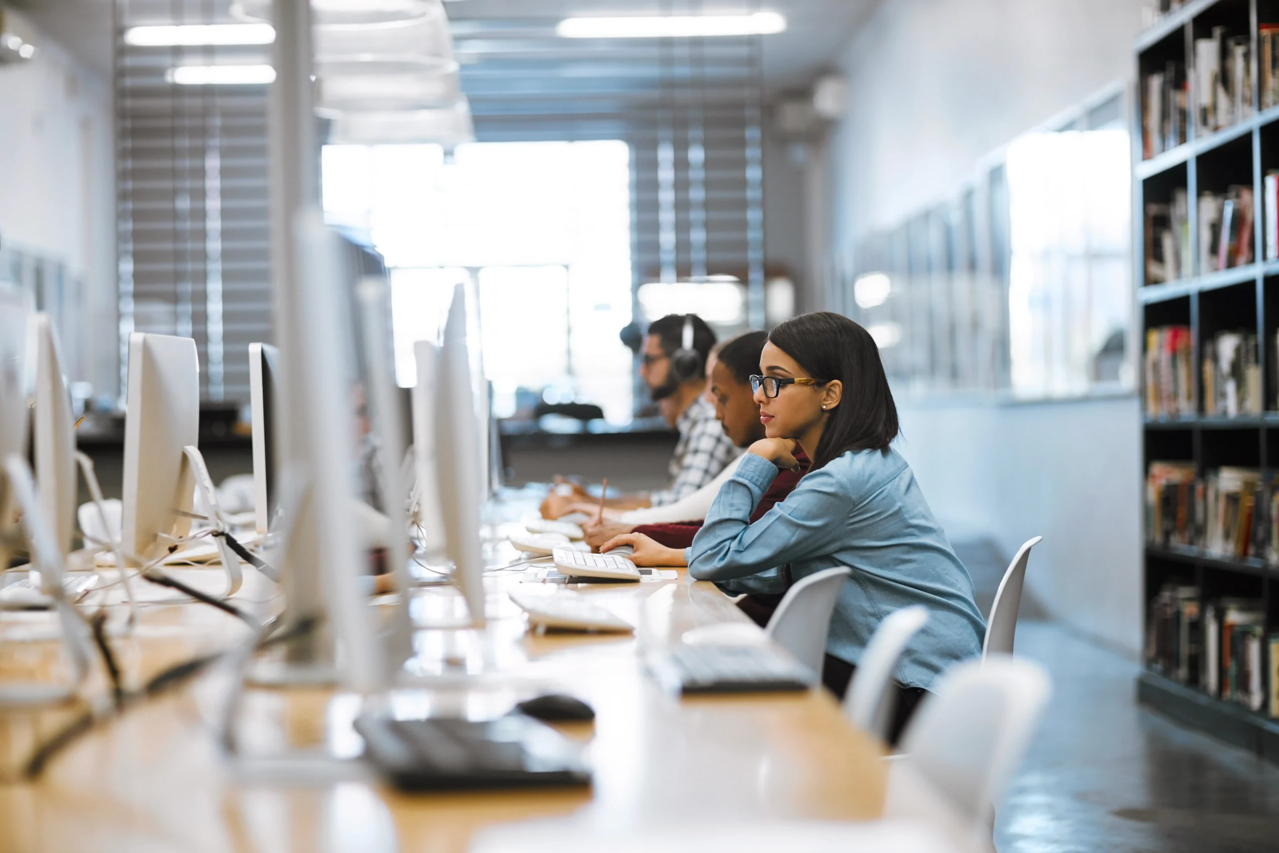 Students working at computers in a university learning space
